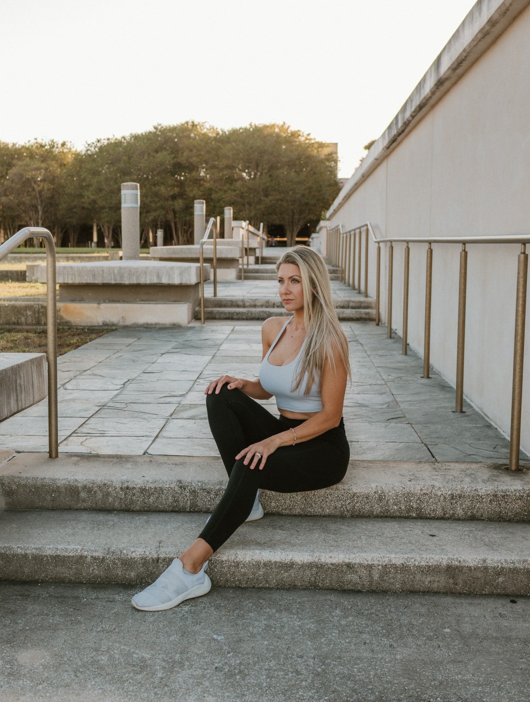 Natalie sitting on steps in outdoor fitness apparel